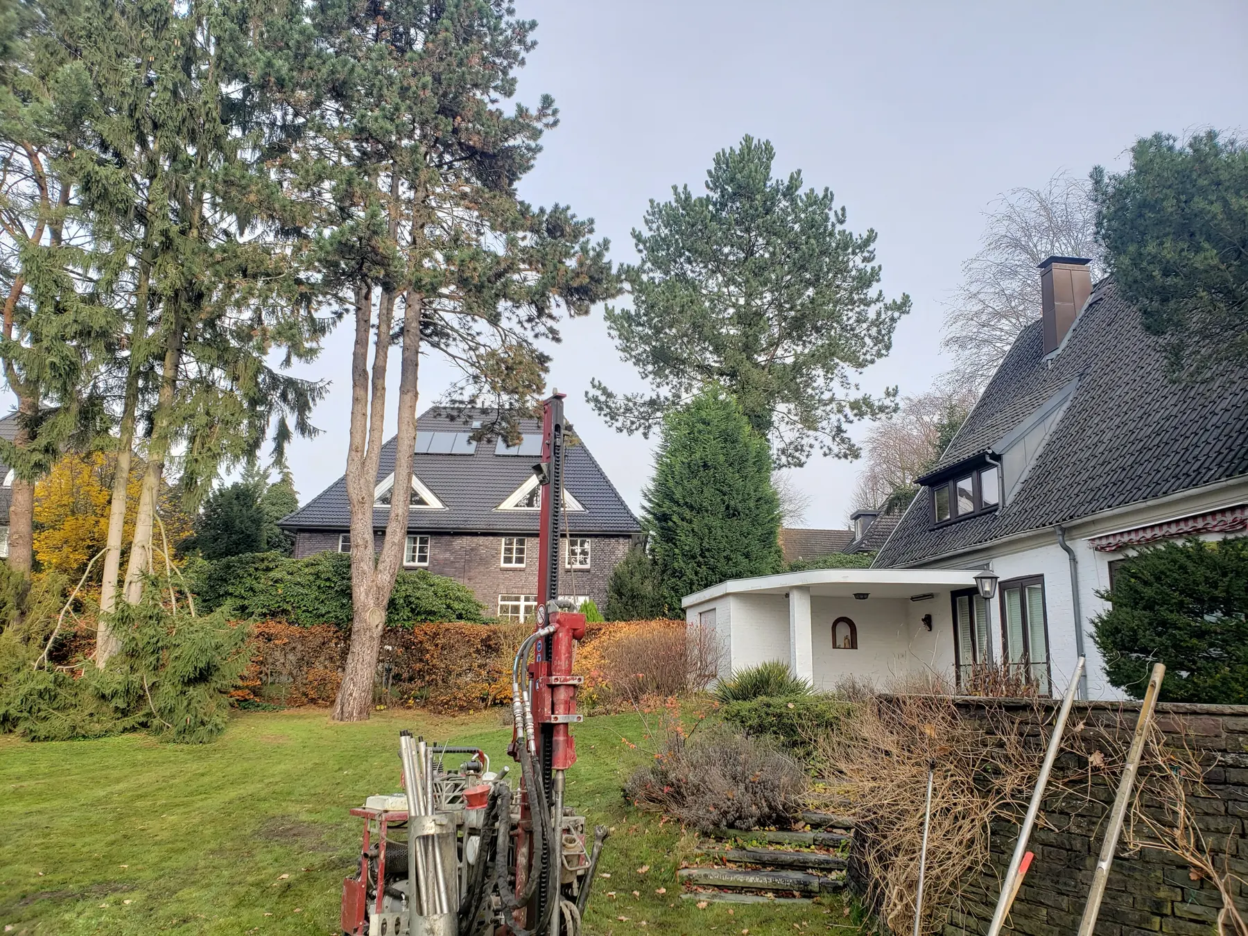 Bohrgerät für eine Rammkernsondierung im Garten eines Wohnhauses, ringsum die Nachbarbebauung